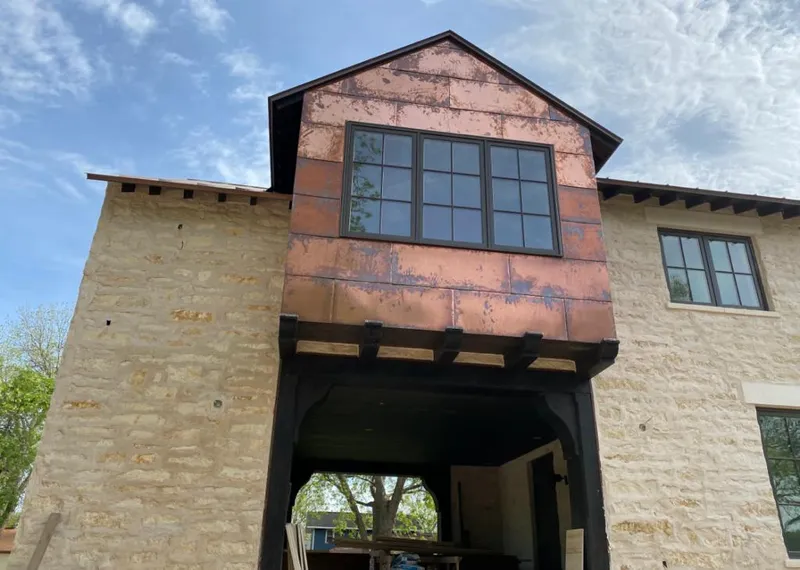 Copper metal panel facade on a stone building for Metal Roof Coating in Covington